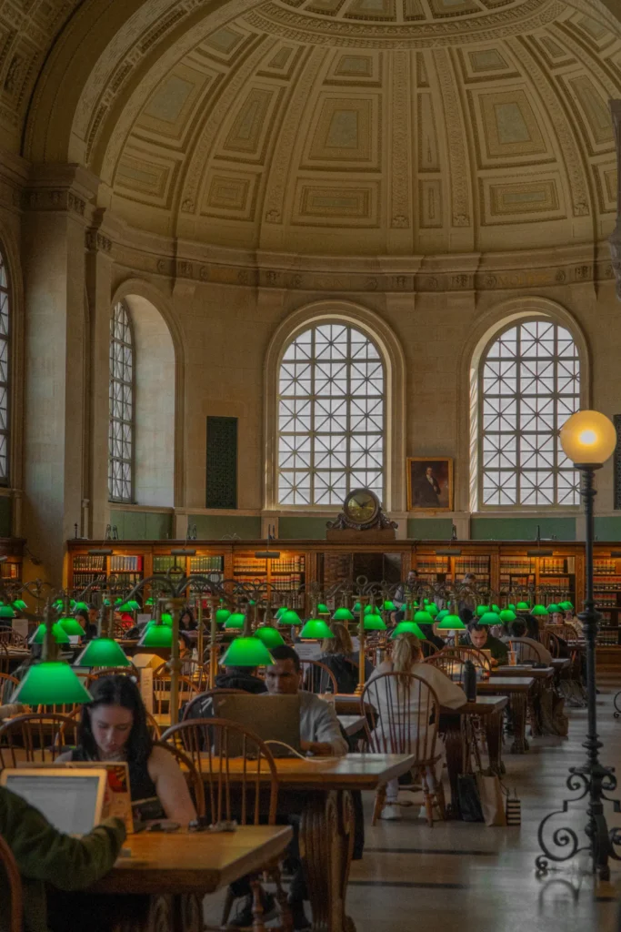 Reading room with green desk lamps and arched windows
