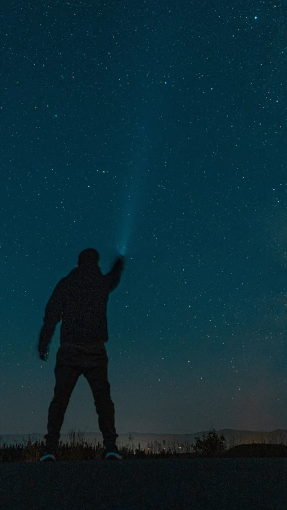 Silhouette of a man against the night sky