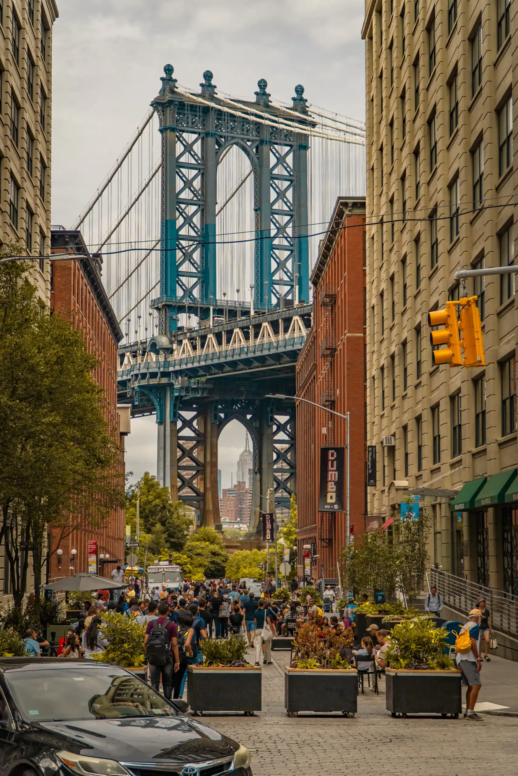 Manhattan Bridge framed between brick buildings in Brooklyn