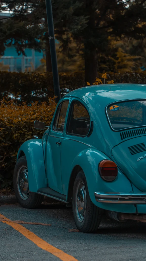 Turquoise Volkswagen Beetle parked on a street