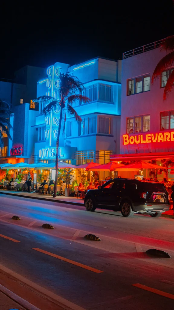 Neon-lit art deco hotels at night